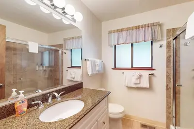 a bathroom with a sink and a toilet and a mirror at High Meadows Retreat in South Lake Tahoe