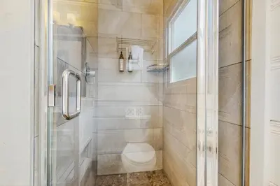 a bathroom with a toilet and a glass shower at Manzanita Holiday 5 in South Lake Tahoe