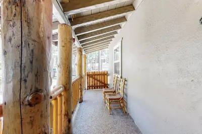 a porch with two wooden chairs and awning at Hank Monk Manor in South Lake Tahoe