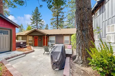a house with a boat parked in the driveway at Manzanita Holiday 2 in South Lake Tahoe
