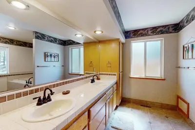 a bathroom with two sinks and a large mirror at Gold Dust Escape in South Lake Tahoe