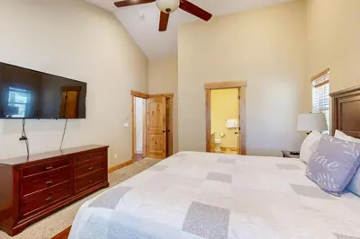 a bedroom with a large bed and a flat screen tv at Wagon Wood Retreat in South Lake Tahoe