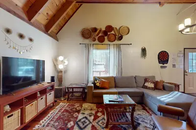 a living room with a couch and a flat screen tv at Genoa Haven in South Lake Tahoe