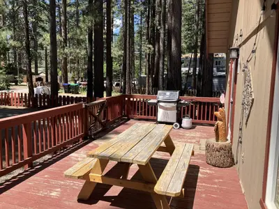a wooden picnic table on a deck with a grill at Genoa Haven in South Lake Tahoe