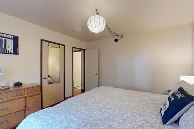 a bedroom with a bed and a dresser and a mirror at Genoa Haven in South Lake Tahoe