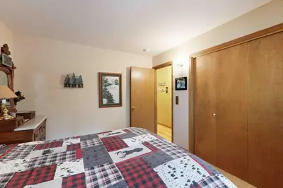 a bedroom with a bed with a quilt on it at Schussing Escape in Truckee
