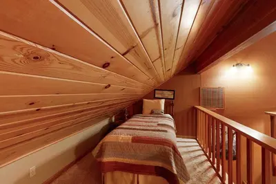 a bed in a room with a wooden ceiling at Schussing Escape in Truckee