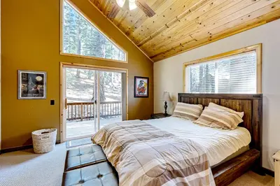 a bedroom with a large bed and a window at Lausanne Getaway in Truckee