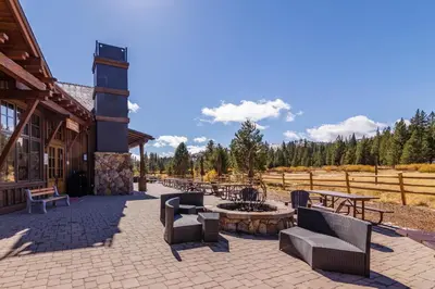 a patio with chairs and a fire pit in front of a building at Lausanne Getaway in Truckee
