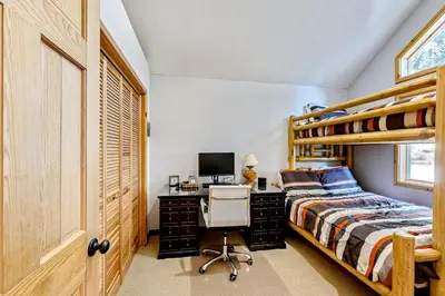 a bedroom with a bunk bed and a desk with a computer at Lausanne Getaway in Truckee