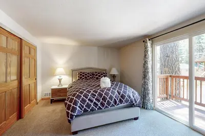 a bedroom with a bed and a large window at Miztec Manor in South Lake Tahoe