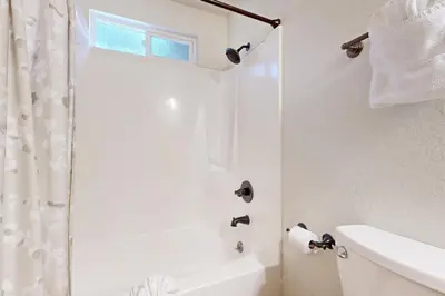a white bathroom with a shower and a sink at Miztec Manor in South Lake Tahoe