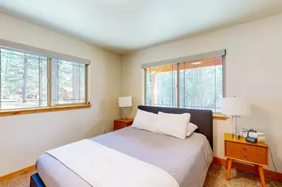 a bedroom with a bed and two windows at Luxury Mountain Retreat in South Lake Tahoe