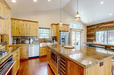 a large kitchen with wooden cabinets and a large island at Luxury Mountain Retreat in South Lake Tahoe
