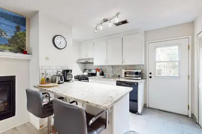a kitchen with white cabinets and a marble counter top at Ski Run Village in South Lake Tahoe