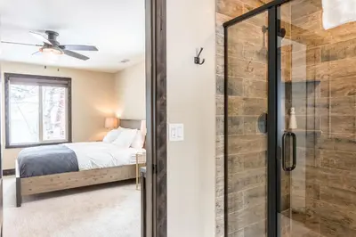 a bedroom with a bed and a glass shower at Lakeview Manor in South Lake Tahoe