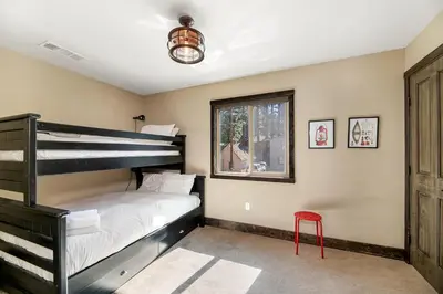 a bedroom with a bunk bed and a window at Lakeview Manor in South Lake Tahoe