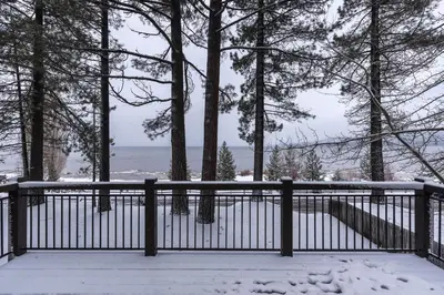 a fence in the snow with a view of the ocean at Lakeview Manor in South Lake Tahoe
