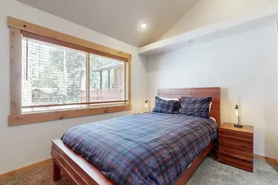 a bedroom with a bed and a large window at Westshore Oasis in Tahoma
