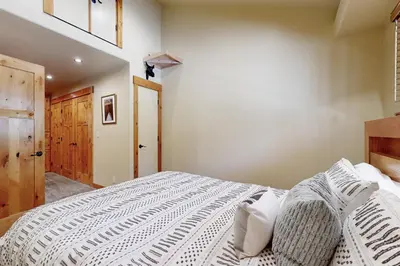 a bedroom with a large bed with white sheets at Westshore Oasis in Tahoma