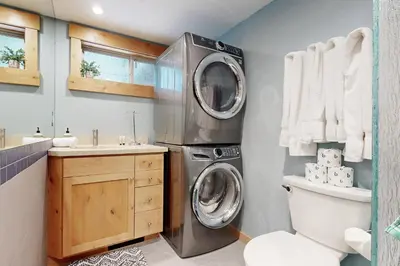 a bathroom with a washing machine and a sink at Westshore Oasis in Tahoma