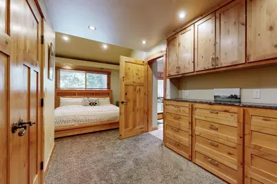 a bedroom with a bed and wooden cabinets at Westshore Oasis in Tahoma
