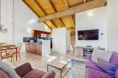 a living room with a couch and a table at Alpine Retreat in Truckee