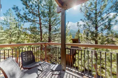 a balcony with two chairs and a view of the mountains at Alpine Retreat in Truckee