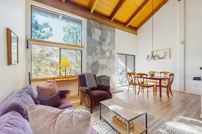 a living room with a couch and a table at Alpine Retreat in Truckee