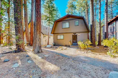 a small house in the middle of a forest at Sky Meadows Charmer in South Lake Tahoe