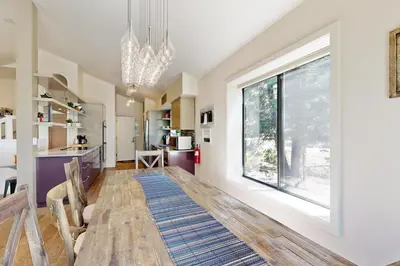 a dining room with a table and a large window at Schussing Paradise in Truckee