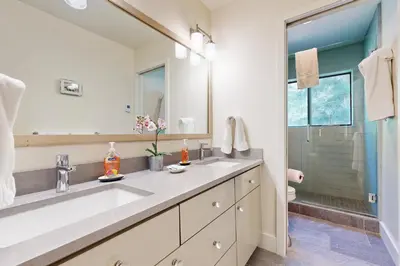 a bathroom with a sink and a mirror and a shower at Schussing Paradise in Truckee