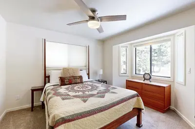 a bedroom with a bed and a ceiling fan at Schussing Paradise in Truckee