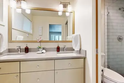 a bathroom with two sinks and a mirror at Schussing Paradise in Truckee