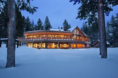 a large house in the snow at night at Schussing Paradise in Truckee