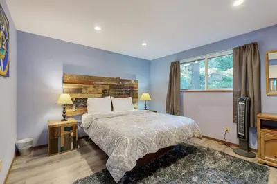 a bedroom with a large bed and a window at Charming Lake Tahoe Cabin in Carnelian Bay