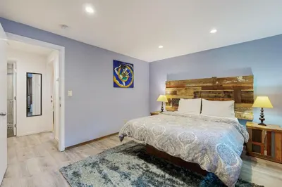 a bedroom with a large bed and a blue wall at Charming Lake Tahoe Cabin in Carnelian Bay