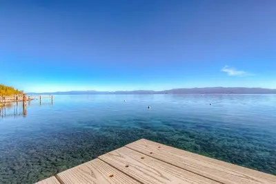 a large body of water with a wooden pier at Cascade Charms in South Lake Tahoe