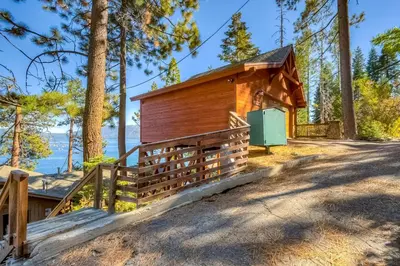 a cabin in the woods with a fence at Cascade Charms in South Lake Tahoe