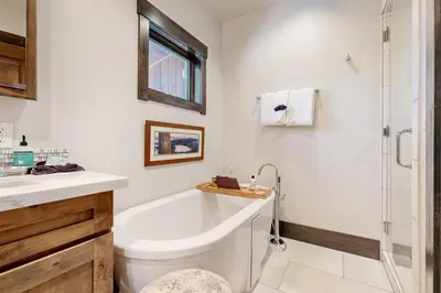 a white bathroom with a tub and a sink at Henness Escape in Truckee