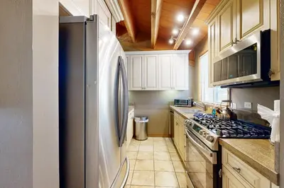 a kitchen with a refrigerator and a stove at Gold Bend Escape in Truckee