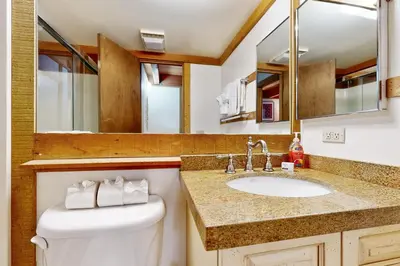 a bathroom with a toilet and a sink and a mirror at Gold Bend Escape in Truckee