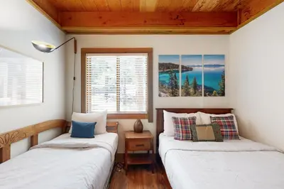 two beds in a room with two windows at Gold Bend Escape in Truckee