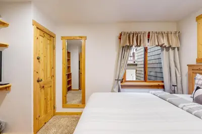 a bedroom with two beds and a window at Coyote Fork 4051 in Truckee