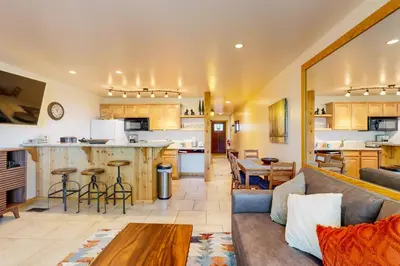 a living room with a couch and a kitchen at Coyote Fork 4051 in Truckee