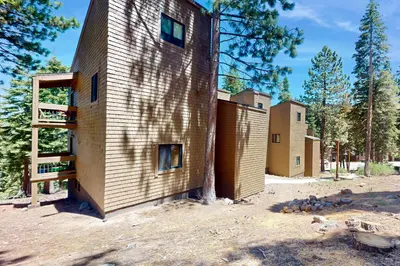 a house clad in wood with trees in the background at Coyote Fork 4051 in Truckee