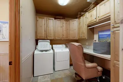 a kitchen with a washer and dryer and a chair at Oslo Manor in Truckee
