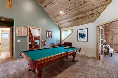 a room with a pool table in a house at Oslo Manor in Truckee