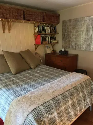 a bedroom with a bed and a dresser at Fivespot Cabin in Pinehurst