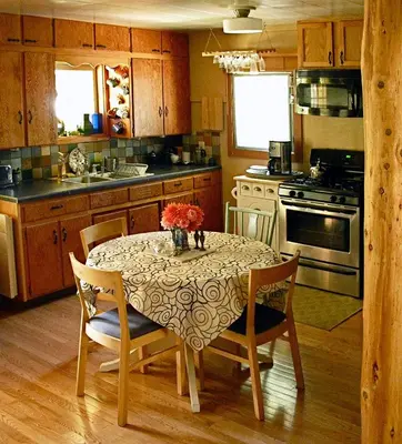 a kitchen with a table with a vase of flowers on it at Fivespot Cabin in Pinehurst